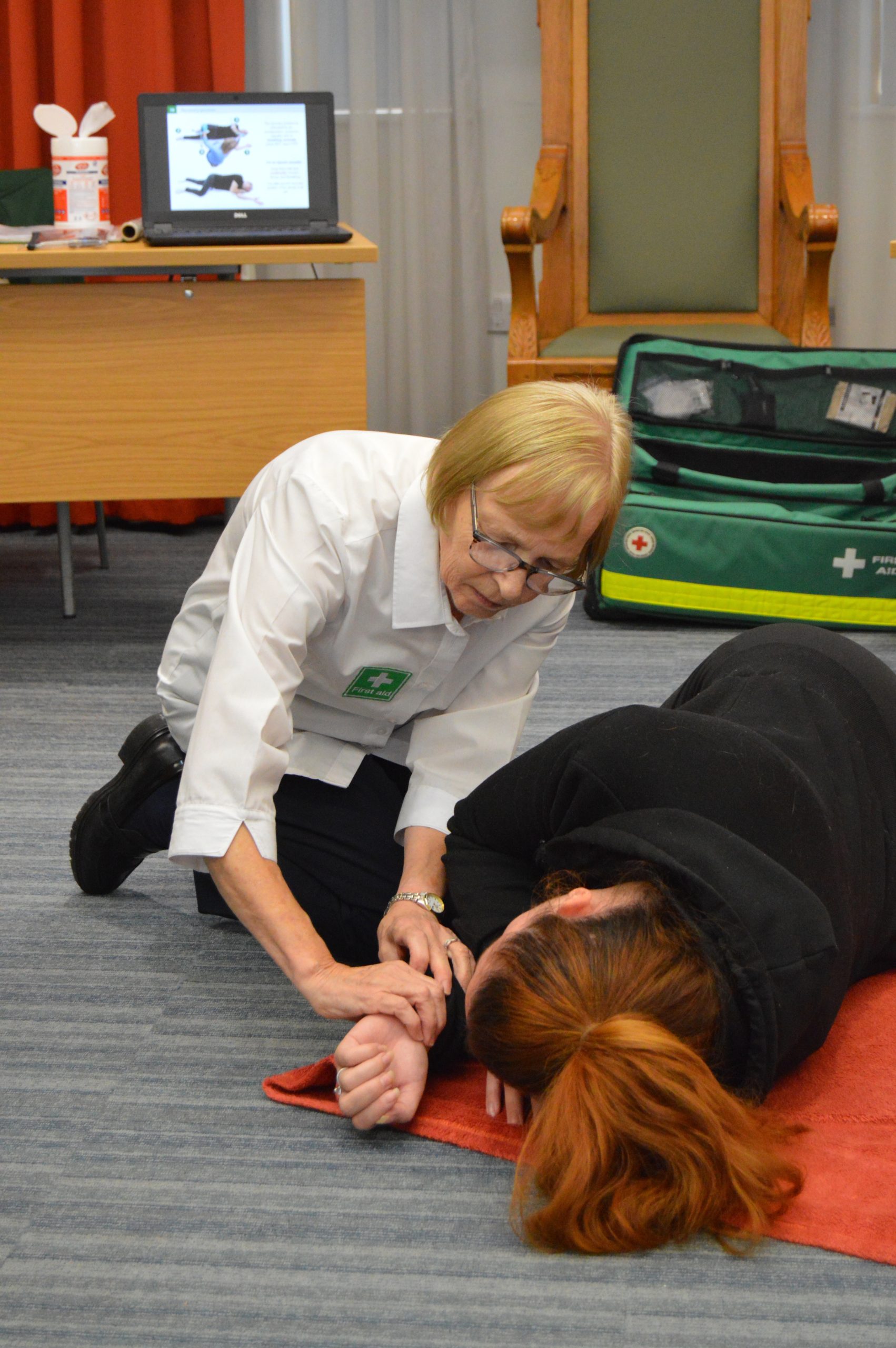 Alison First Aid Trainer demonstrating recovery position during a First aid at work course with New Forest First Aid Training.