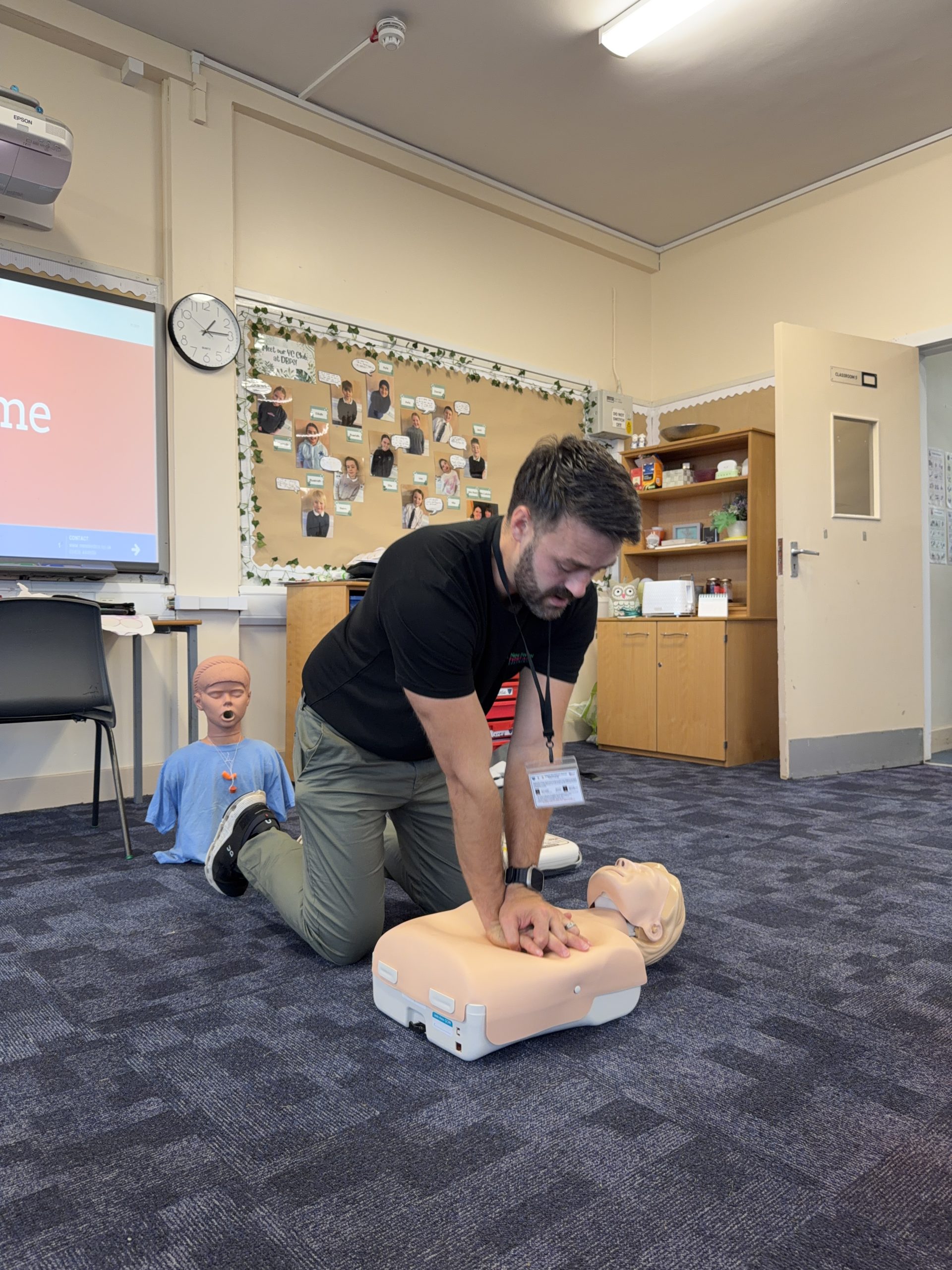 James demonstrating Compressions in first aid training for school children.