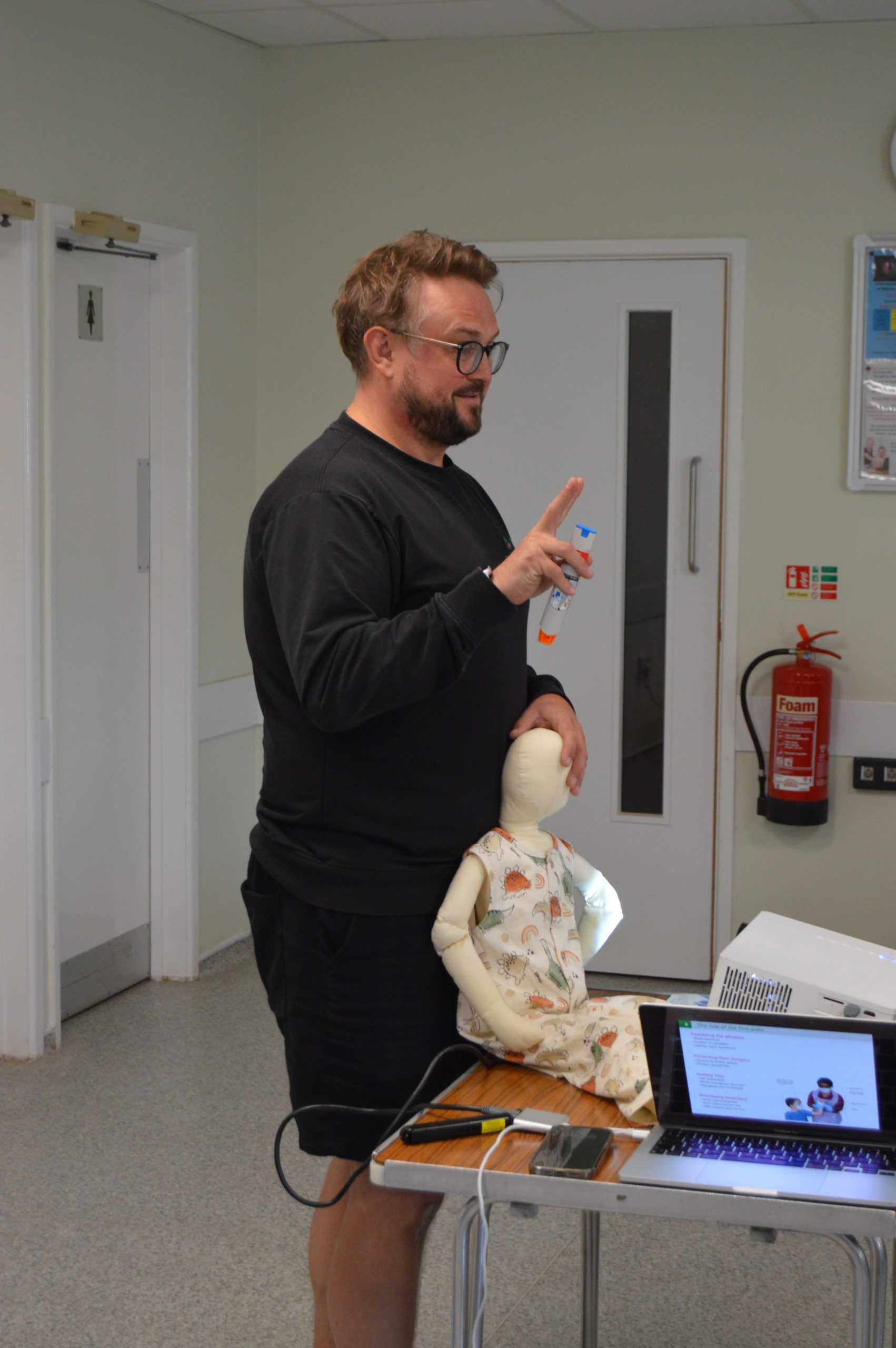 Joe showing auto-injector. First Aid training EFAW