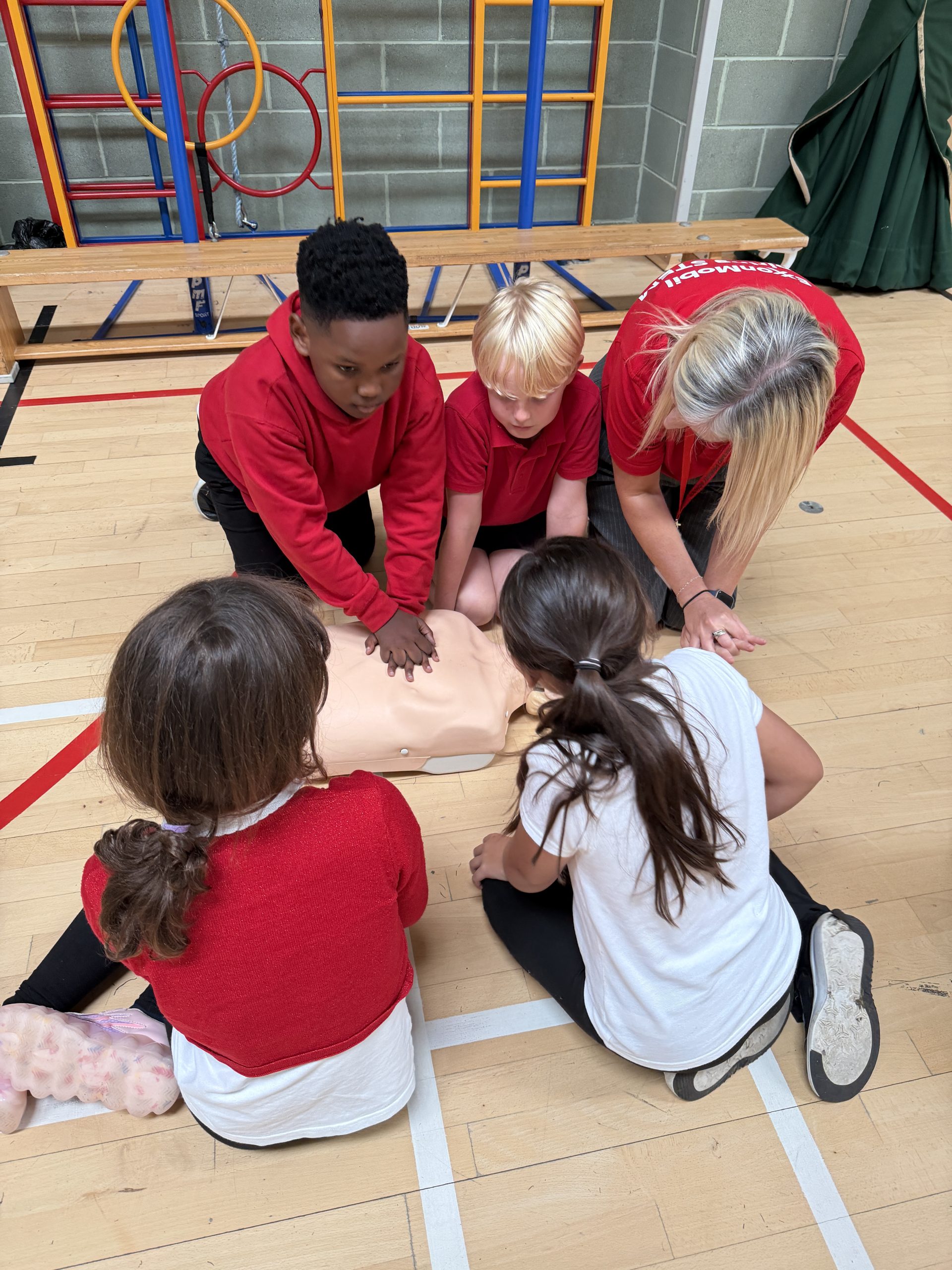 Group of Mini Medics compressions in a Mini Medics first aid course.