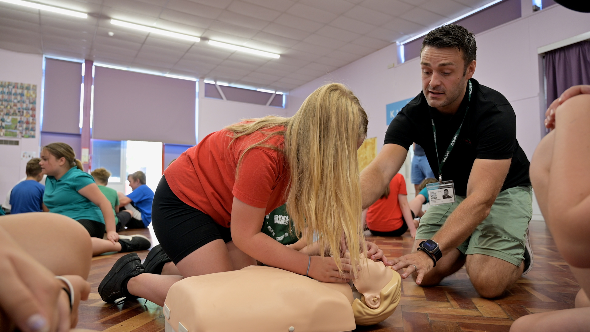 First Aid trainer instructing Mini Medic in Airway management First Aid Training.